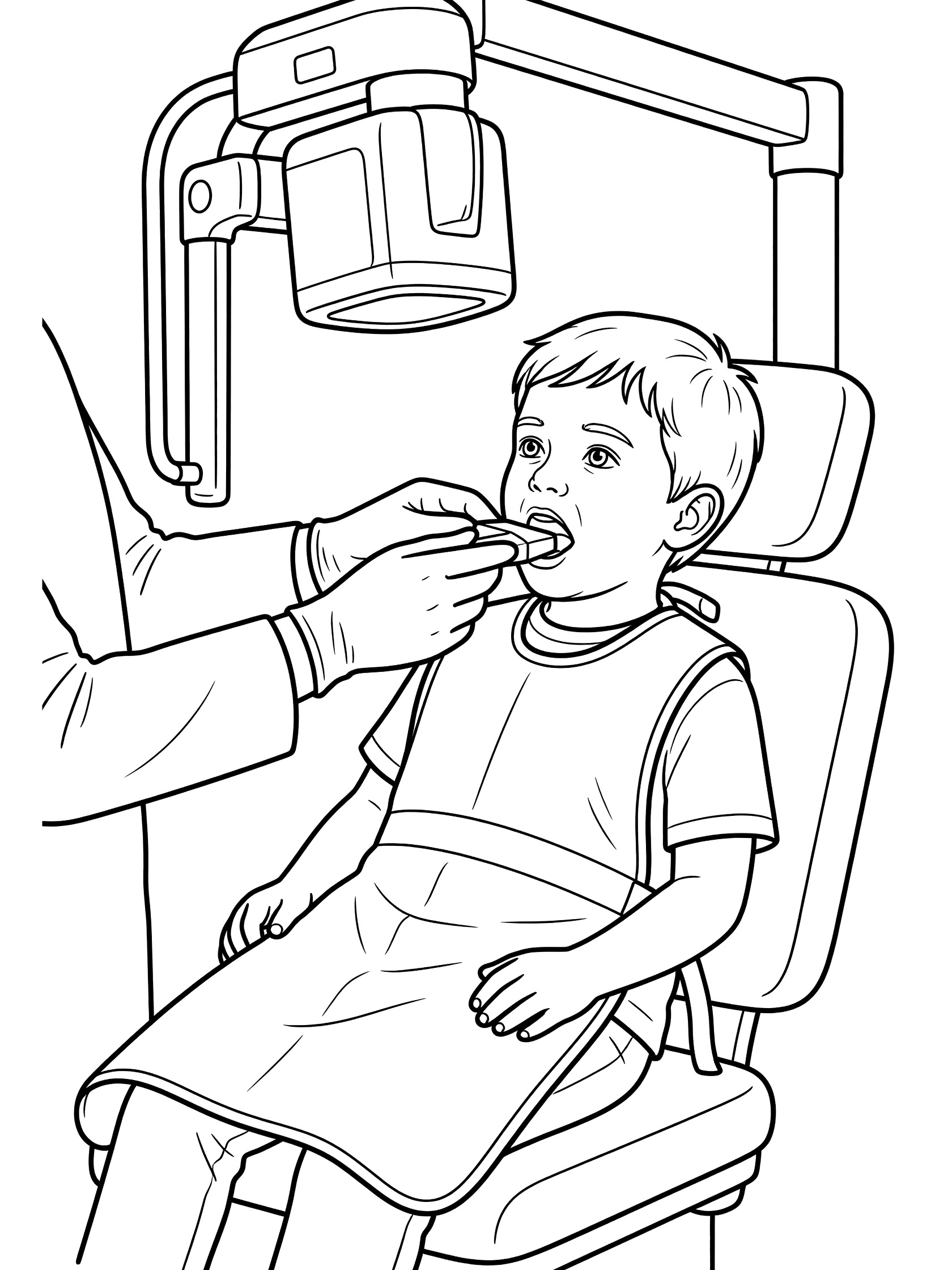 Dentist in gloves holding sensor in young boy's mouth while he sits in dental chair with protective apron during x-ray. X-ray machine arm overhead.